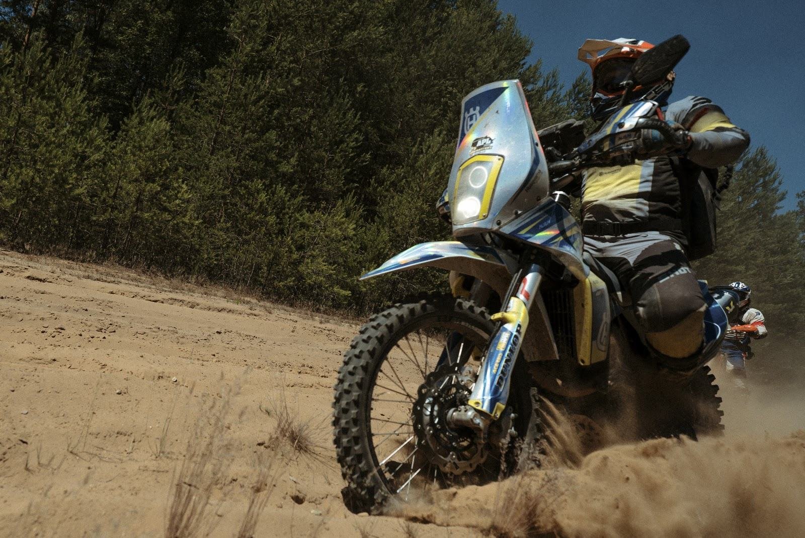 Enduro motociklas posūkyje smėlyje